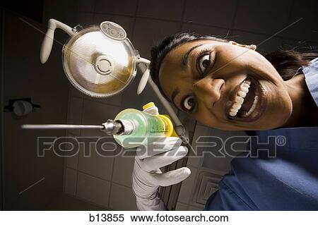Dental hygienist with syringe dramatic angle View Large Photo Image Stock Photography - Dental hygienist with syringe dramatic angle. Fotosearch