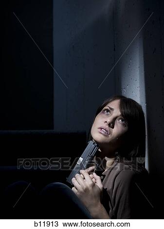Stock Image - Depressed and suicidal young woman. Fotosearch