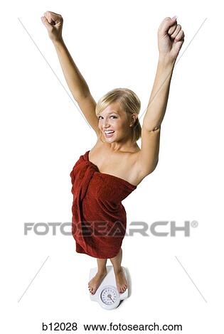 Dieting woman standing on bathroom scale View Large Photo Image Stock Photo - Dieting woman standing on bathroom scale. Fotosearch
