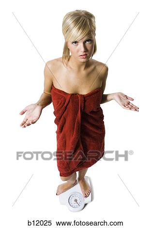 Dieting woman standing on bathroom scale View Large Photo Image Stock Photography - Dieting woman standing on bathroom scale. Fotosearch
