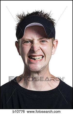 Stock Photograph - Disheveled man with a visor grinning. Fotosearch