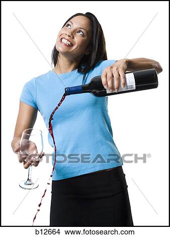 Distracted woman pouring red wine and missing glass View Large Photo Image Picture - Distracted woman pouring red wine and missing glass. Fotosearch