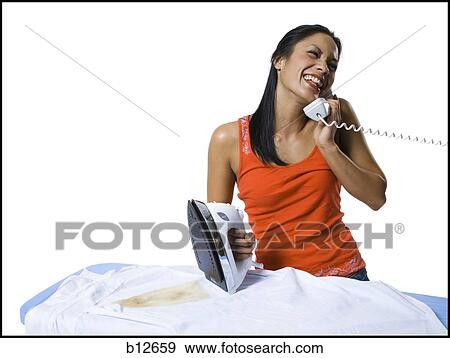 Stock Photo - Distracted woman with iron and burned clothing. Fotosearch