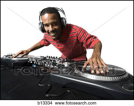 DJ with headphones spinning records View Large Photo Image Picture - DJ with headphones spinning records. Fotosearch