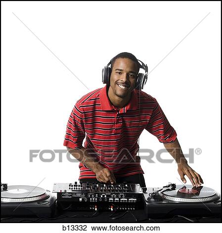 Stock Image - DJ with headphones spinning records. Fotosearch