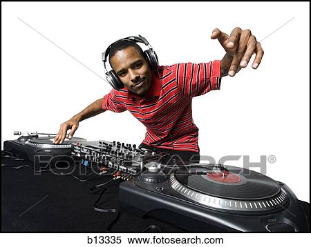 Stock Photography - DJ with headphones spinning records. Fotosearch