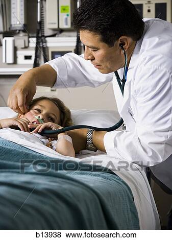 Stock Photo - Doctor examining young girl in hospital with stethoscope. Fotosearch