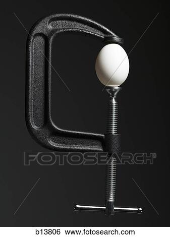 Stock Photograph - Egg in vice. Fotosearch
