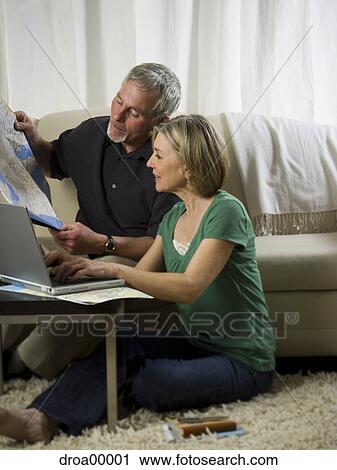 Elderly couple sitting in front of a laptop and looking at a map View Large Photo Image Stock Image - Elderly couple sitting in front of a laptop and looking at a map. Fotosearch