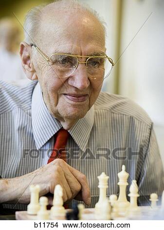 Picture - Elderly man playing chess. Fotosearch
