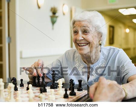 Stock Photo - Elderly woman playing chess. Fotosearch