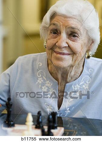 Stock Photography - Elderly woman playing chess. Fotosearch