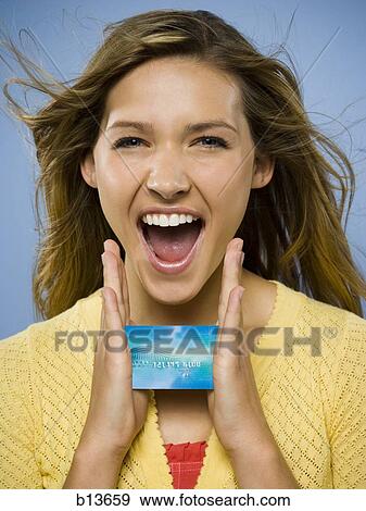 Stock Photo - Excited woman with credit card. Fotosearch