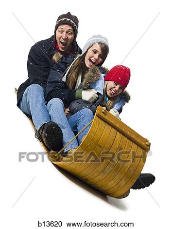 Stock Image - Family on toboggan. Fotosearch