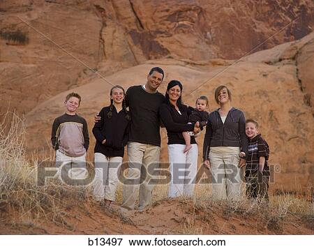 Stock Photo - Family standing in front of rock formation. Fotosearch