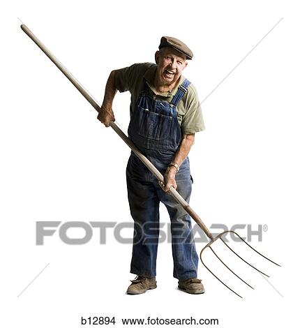 Farmer holding a pitchfork View Large Photo Image Picture - Farmer holding a pitchfork. Fotosearch