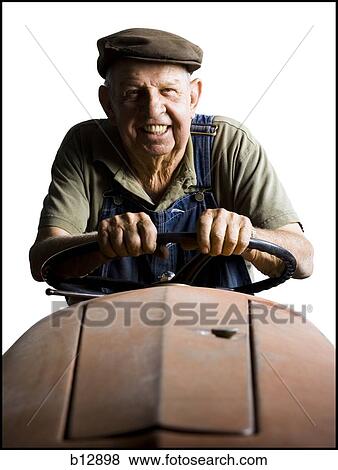 Farmer posing with his tractor View Large Photo Image Stock Photo - Farmer posing with his tractor. Fotosearch
