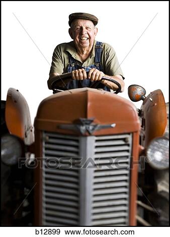 Farmer posing with his tractor View Large Photo Image Stock Photo - Farmer posing with his tractor. Fotosearch