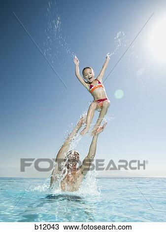 Father and daughter playing in infinity pool View Large Photo Image Stock Image - Father and daughter playing in infinity pool. Fotosearch