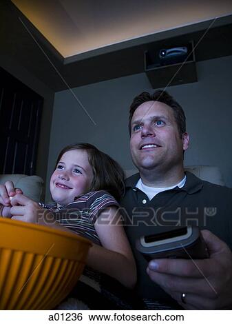 Father and daughters watching movie in home theater View Large Photo Image Stock Photograph - Father and daughters watching movie in home theater. Fotosearch