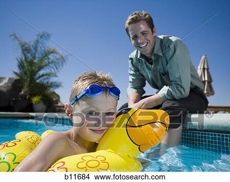 Picture - Father and son at swimming pool. Fotosearch