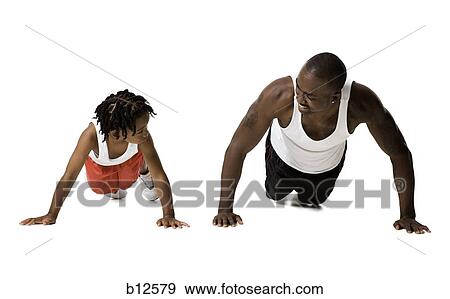 Stock Photo - Father and son doing push ups. Fotosearch