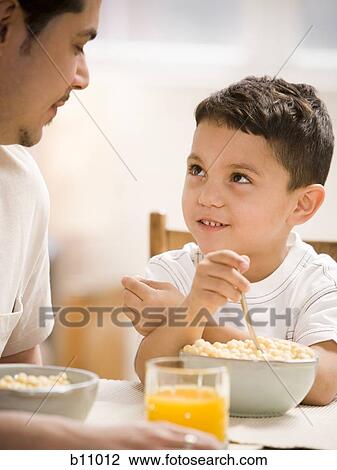 Father and young son having breakfast together View Large Photo Image Stock Image - Father and young son having breakfast together. Fotosearch