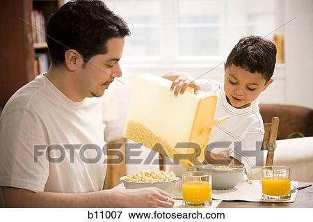 Father and young son having breakfast together View Large Photo Image Stock Photo - Father and young son having breakfast together. Fotosearch
