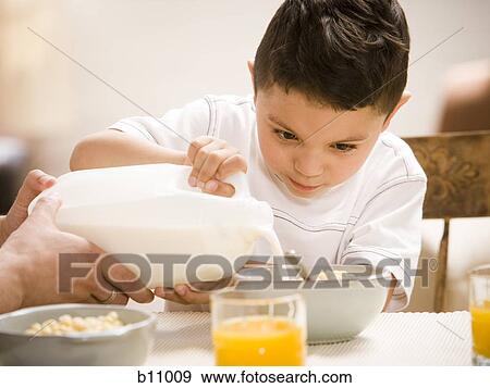 Stock Photo - Father and young son having breakfast together. Fotosearch