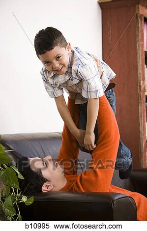 Father and young son playing View Large Photo Image Stock Photography - Father and young son playing. Fotosearch