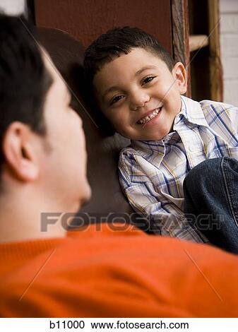 Stock Image - Father and young son talking. Fotosearch