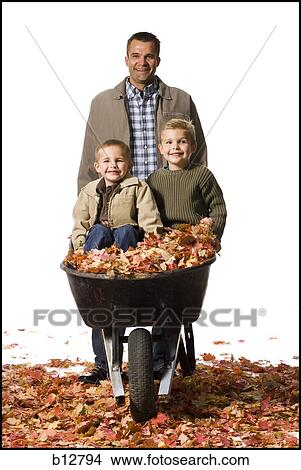 Father pushing two sons in a wheelbarrow View Large Photo Image Picture - Father pushing two sons in a wheelbarrow. Fotosearch