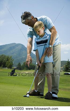 Father teaching his son to play golf View Large Photo Image Stock Image - Father teaching his son to play golf. Fotosearch
