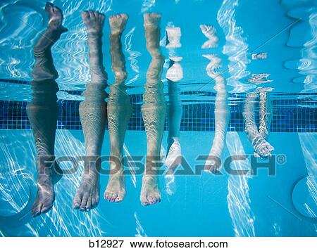 Feet dangling in swimming pool View Large Photo Image Stock Photo - Feet dangling in swimming pool. Fotosearch
