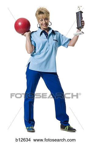Picture - Female bowler holding trophy. Fotosearch