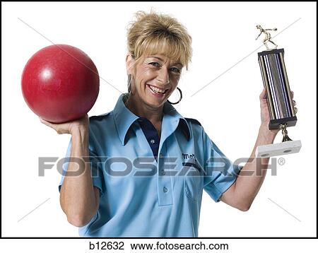 Female bowler holding trophy View Large Photo Image Stock Image - Female bowler holding trophy. Fotosearch