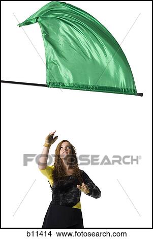 Female color guard twirling flag View Large Photo Image Picture - Female color guard twirling flag. Fotosearch