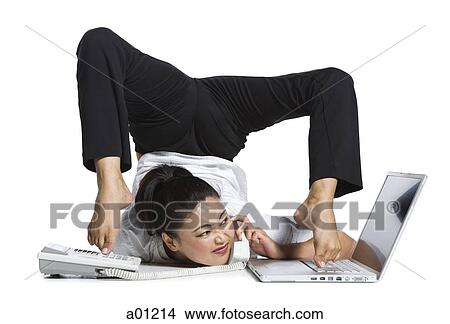 Picture - Female contortionist businesswoman. Fotosearch