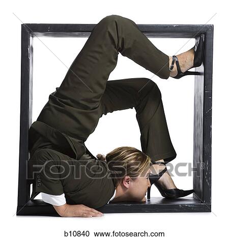 Stock Image - Female contortionist businesswoman inside the box. Fotosearch