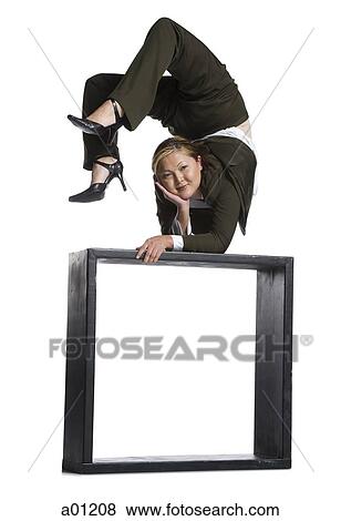 Female contortionist businesswoman outside the box View Large Photo Image Stock Photo - Female contortionist businesswoman outside the box. Fotosearch
