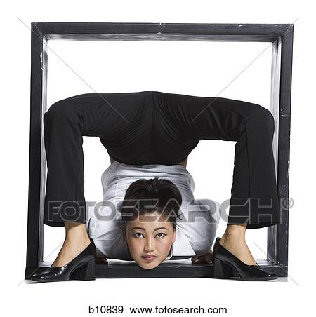 Female contortionist businesswoman inside the box View Large Photo Image Stock Photo - Female contortionist businesswoman inside the box. Fotosearch