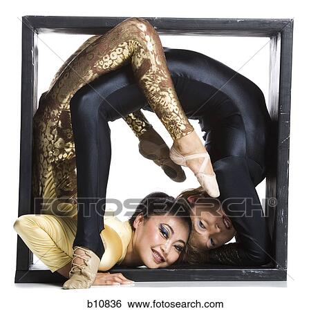 Female contortionist duo inside the box View Large Photo Image Stock Photograph - Female contortionist duo inside the box. Fotosearch