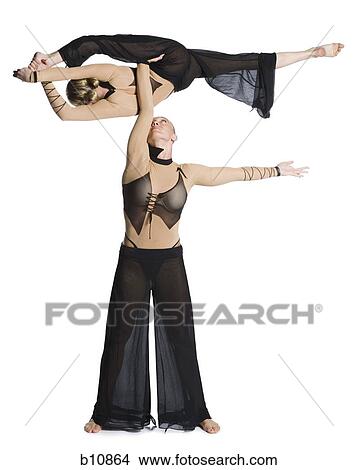Picture - Female contortionist duo performing. Fotosearch