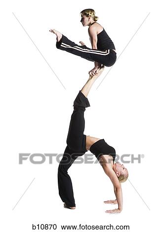 Female contortionist duo performing View Large Photo Image Stock Image - Female contortionist duo performing. Fotosearch