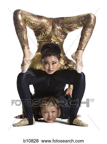Stock Photo - Female contortionist duo performing. Fotosearch