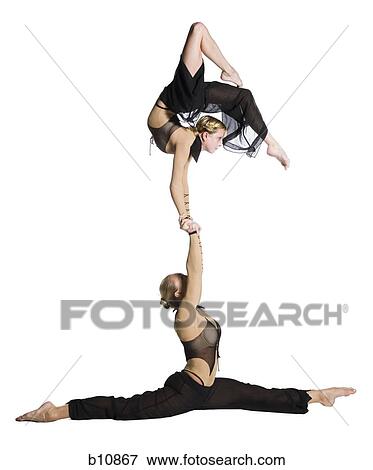 Stock Photo - Female contortionist duo performing. Fotosearch