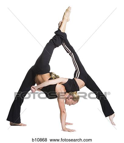 Female contortionist duo performing View Large Photo Image Stock Photo - Female contortionist duo performing. Fotosearch