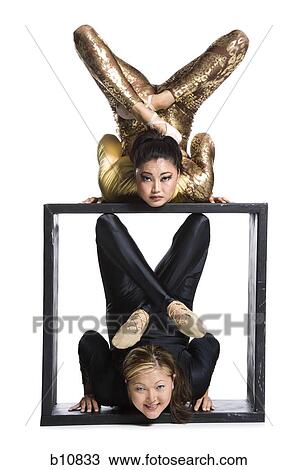 Female contortionist duo with box prop View Large Photo Image Stock Image - Female contortionist duo with box prop. Fotosearch