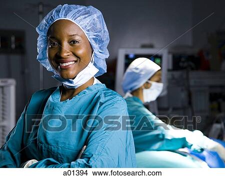 Female doctor in scrubs with arms crossed smiling View Large Photo Image Picture - Female doctor in scrubs with arms crossed smiling. Fotosearch