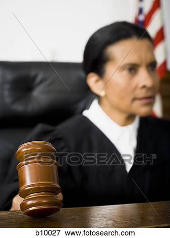 Stock Photo - Female judge holding a gavel. Fotosearch